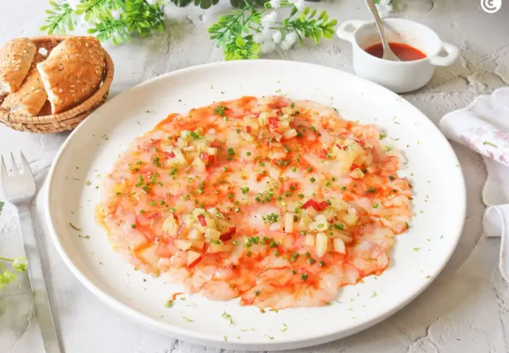Delicioso carpaccio de gamba roja, finas láminas de gamba cruda con aderezo y picadillo de verduras.