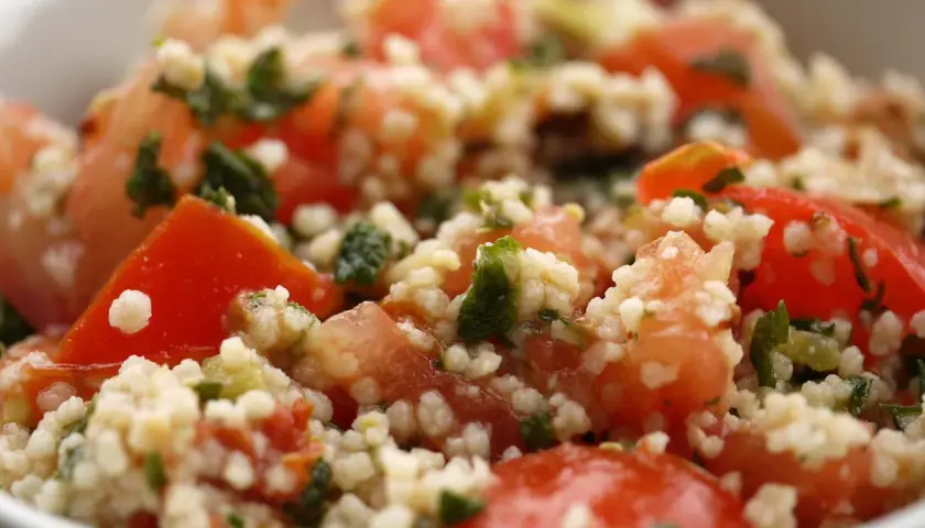 Delicioso cuscus con verduras frescas, tomates jugosos y hierbas aromáticas.